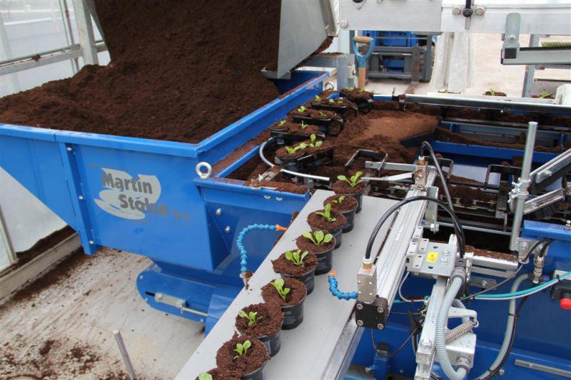Machines gespecialiseerd in het containeriseren van planten voor gemakkelijke transport en opslag.